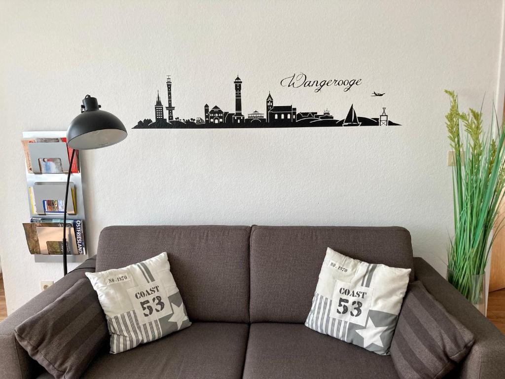 a couch in a living room with a city skyline sticker at Anton-Gunther-Str 16 in Wangerooge