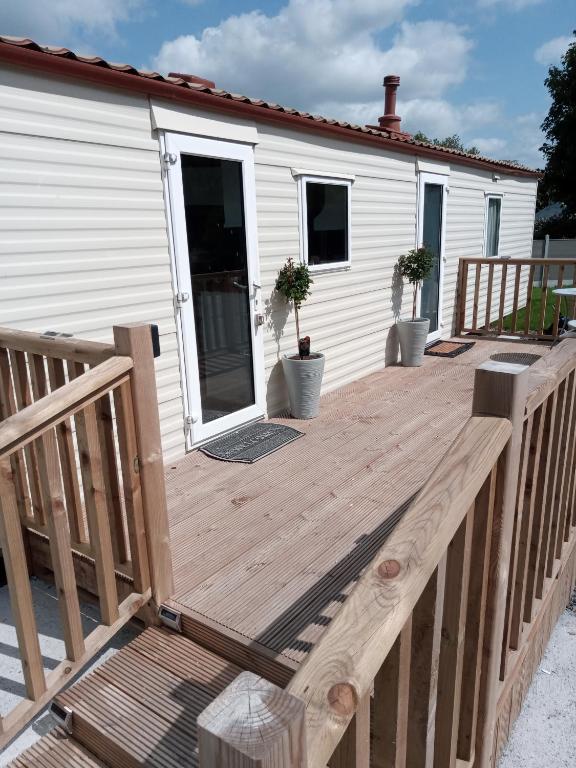 a wooden deck in front of a house at The Rock Bar B&B in Kilkenny