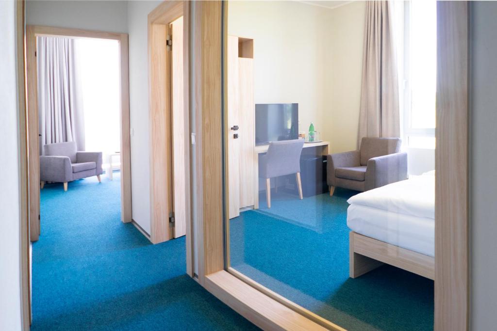 Postel nebo postele na pokoji v ubytování Hotel Vinice Hnanice