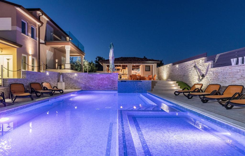 a swimming pool in front of a house at Luxurious Villa Istra Kamen in Pula