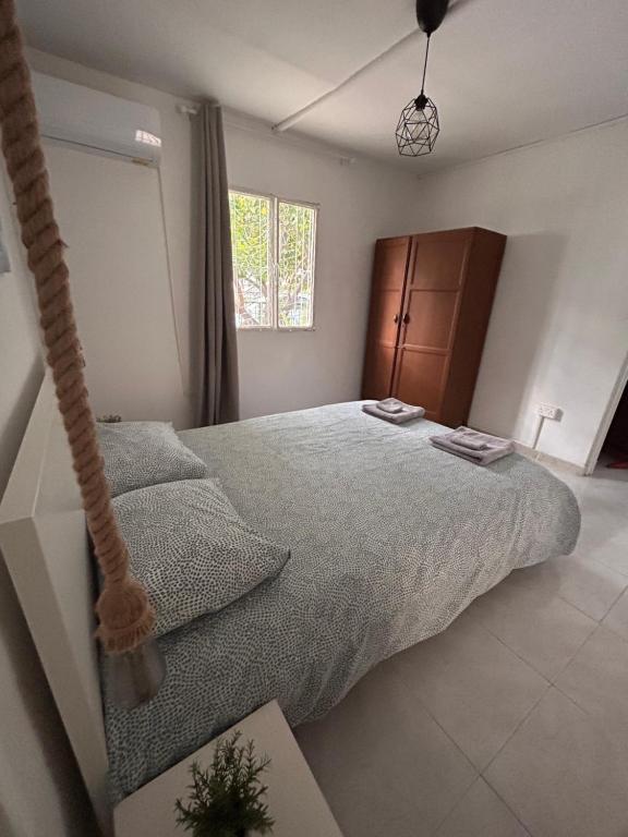 a bedroom with a large bed and a hanging bedsenal at Avra House in Limassol