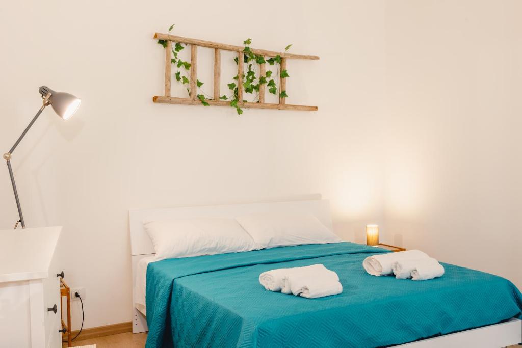 a bedroom with a bed with two towels on it at ConVivo Apartment Palazzo Galateo in Lecce