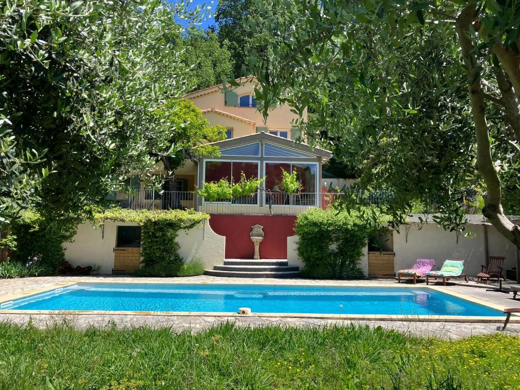a house with a swimming pool in front of a house at Villa Belle Vue in Saint Paul de Vence