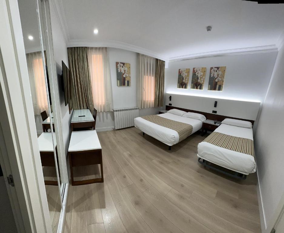 A bed or beds in a room at Hostal Abadia Madrid