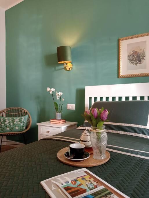 pokój z łóżkiem ze stołem i kwiatami w obiekcie Dom Apartment Luxury w Cagliari