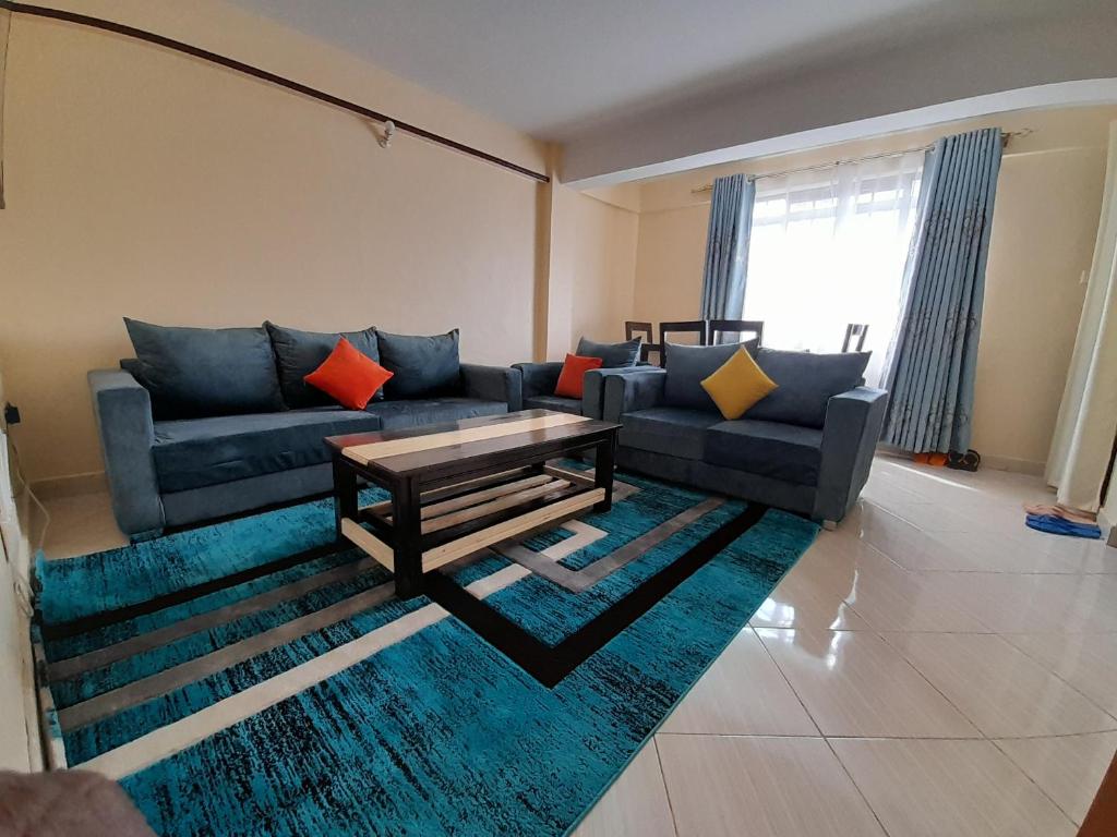 a living room with a couch and a table at Milimani Nanyuki in Nanyuki