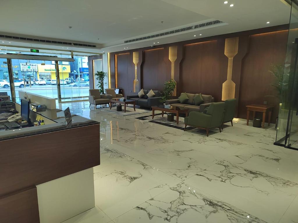 a lobby with couches and tables in a building at نمار هوم للاجنحة المخدومة -طويق in Riyadh