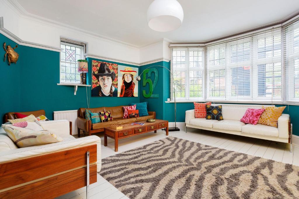 a living room with two couches and a zebra rug at Veeve - Highgate High Notes in London