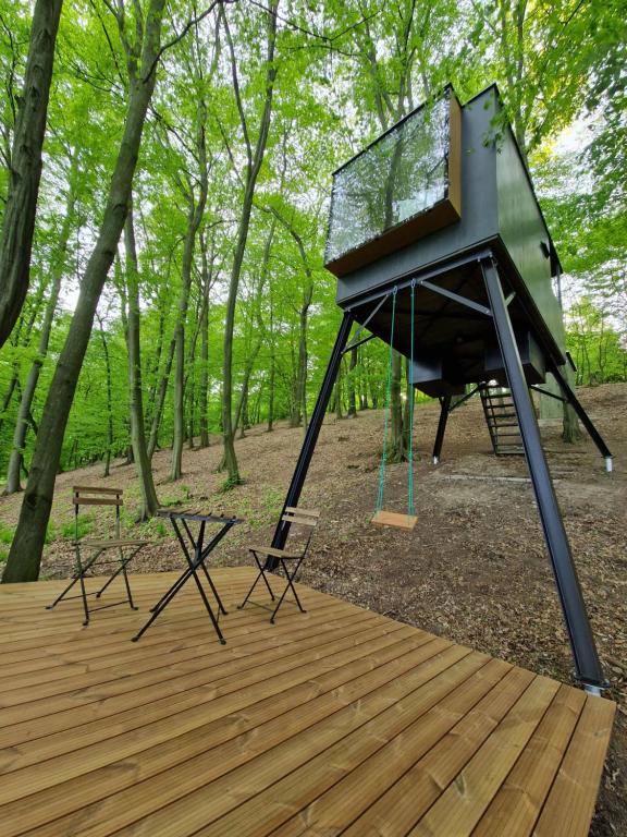 a swing set on a deck in the woods at Posed STRÁŽNICE 