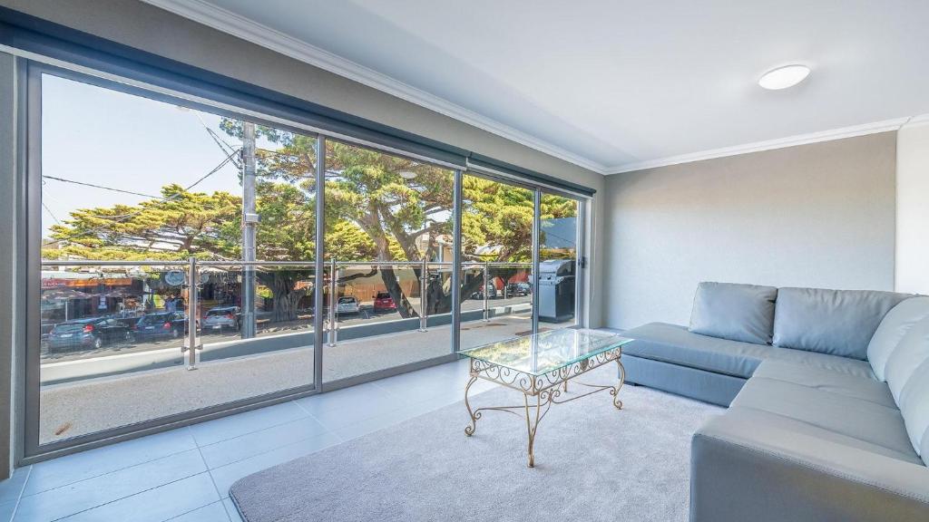 a living room with a couch and a large window at 1-83 Thompson Avenue, Cowes in Cowes