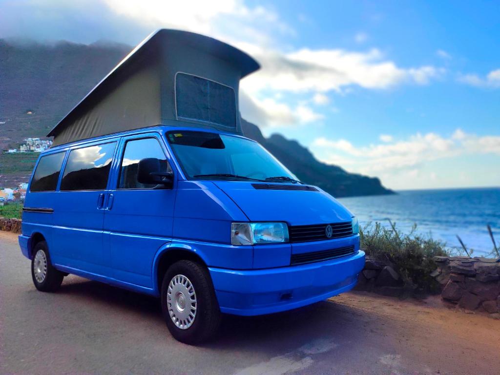 a blue van with a camper on top of it at Furgoneta Camper En La Gomera in San Sebastián de la Gomera