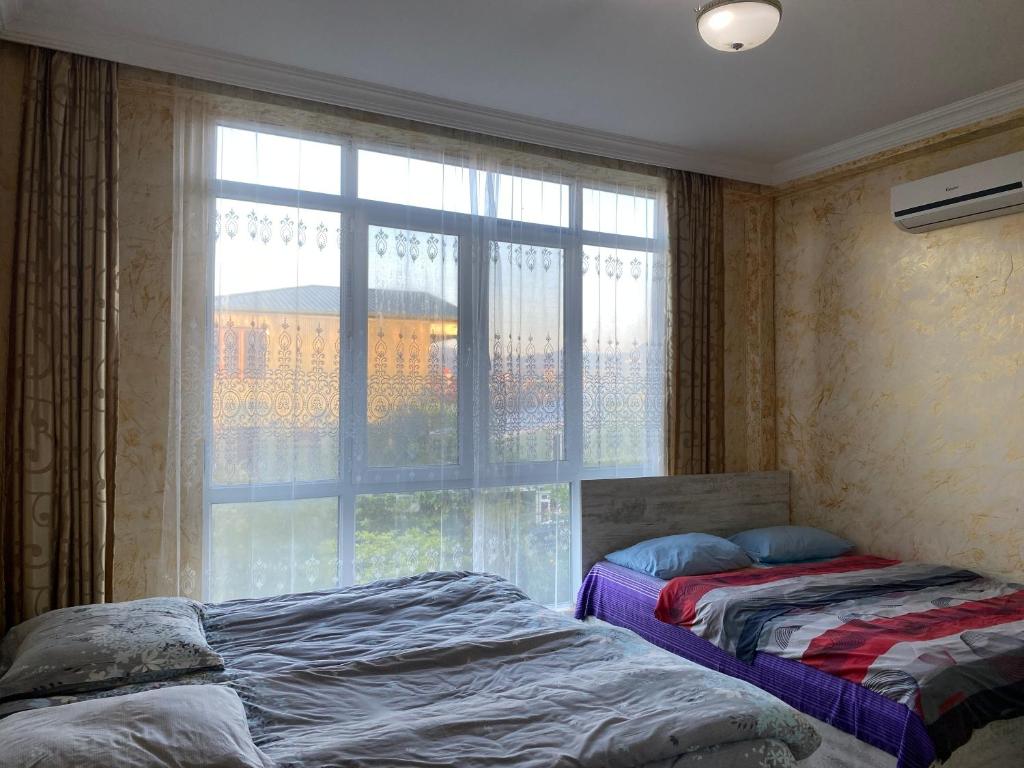 Postel nebo postele na pokoji v ubytování Merab House