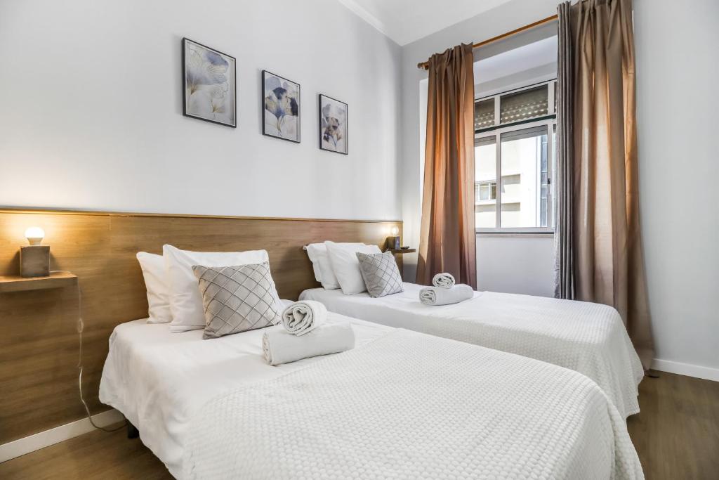 Tempat tidur dalam kamar di Lisboa Charming Apartment II