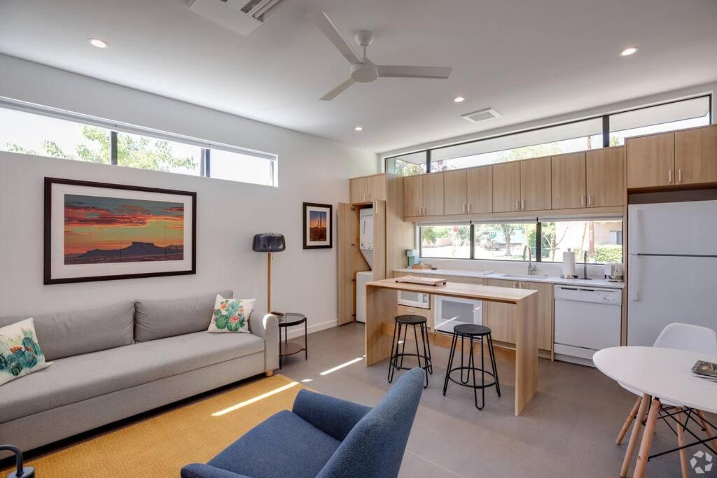 a living room with a couch and a kitchen at Unique Design 2-bedroom Apartment - 80 Walkscore! in Phoenix