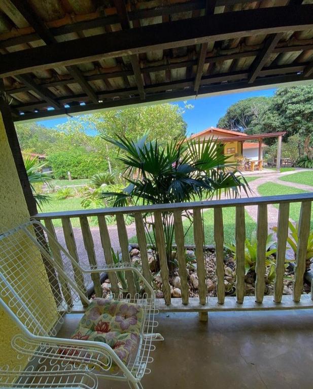 a balcony with a basket of fruit on a chair at Pousada Embaubas in Serra do Cipo