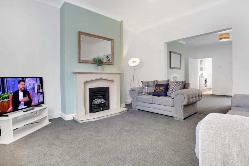 a living room with a tv and a fireplace at Sleek Gem Home in Houghton le Spring, Sleeps 5 in Houghton le Spring
