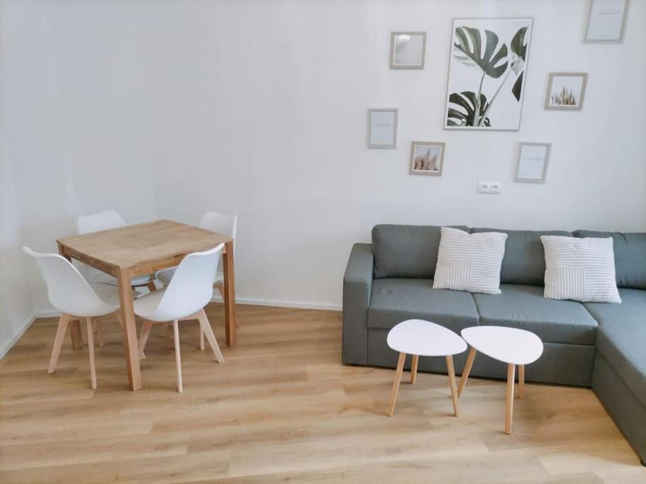a living room with a couch and a table and chairs at Ferienwohnung Luitpold 1 in Memmingen