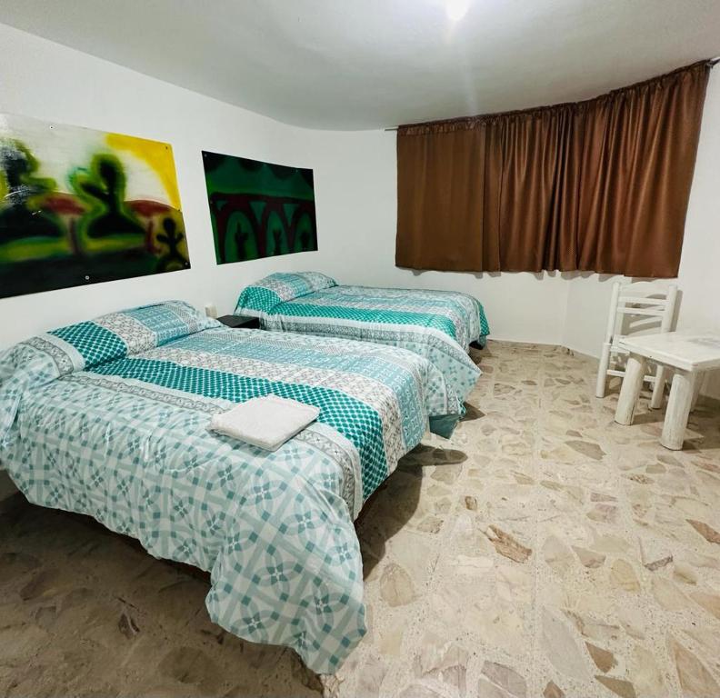 Rúm í herbergi á Hotel Villa 12 Orquídeas