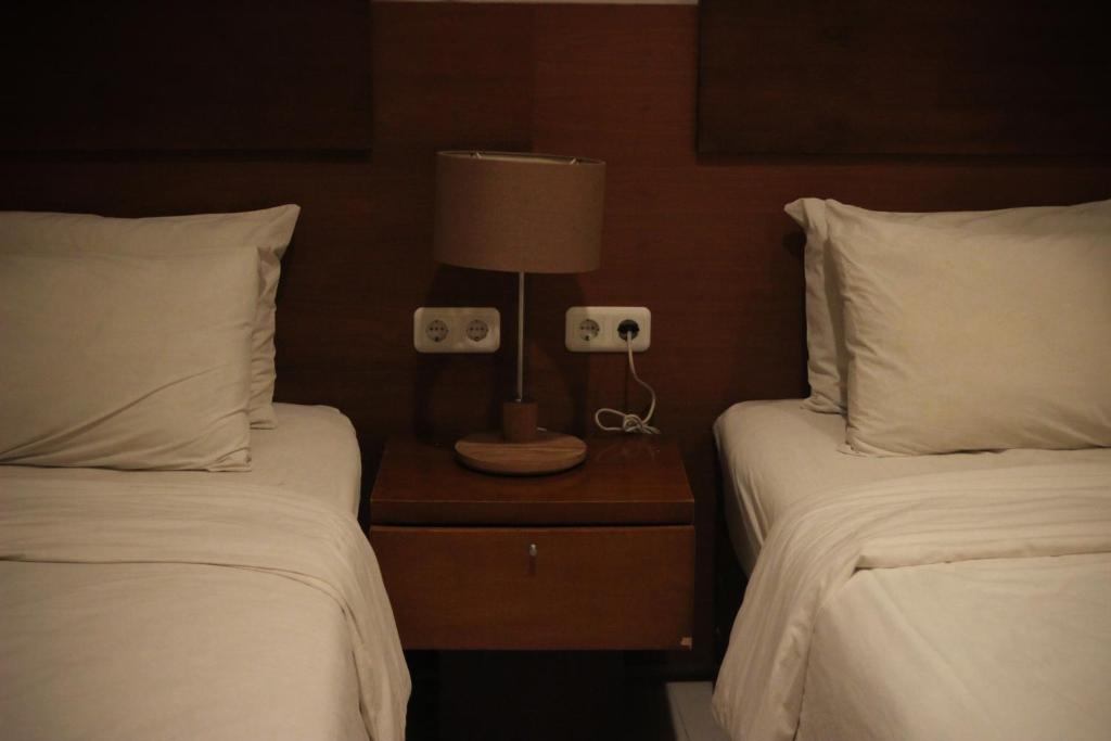 Postel nebo postele na pokoji v ubytování Hotel Graha Kinasih Kotabaru