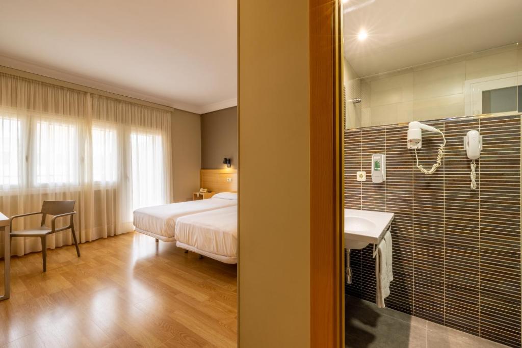 Postel nebo postele na pokoji v ubytování Hotel Santamaria