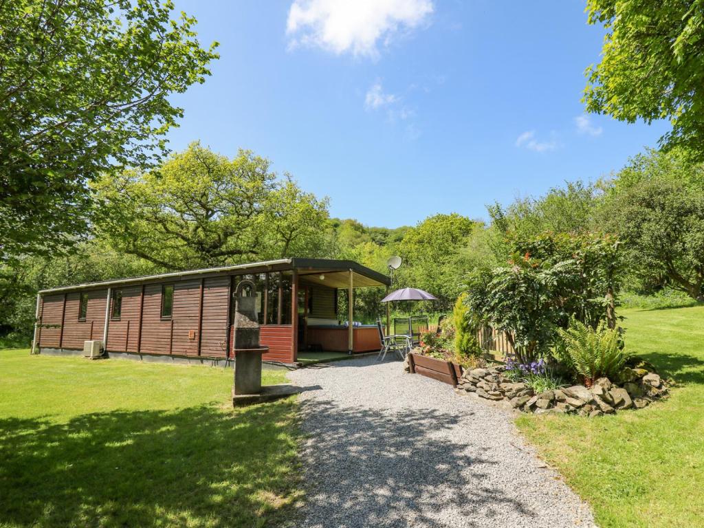 a cabin in a park with a path leading to it at Brook Lodge in Llandysul