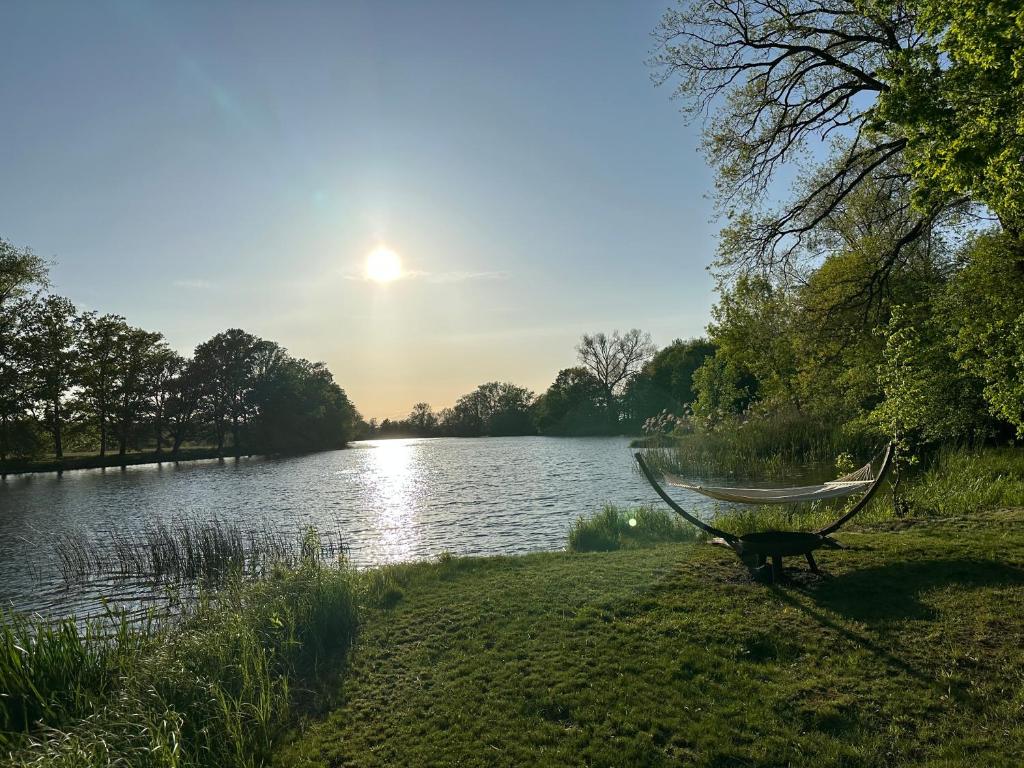 a hammock on the shore of a lake at Villa Schuwardt auf Nordend in Rathenow