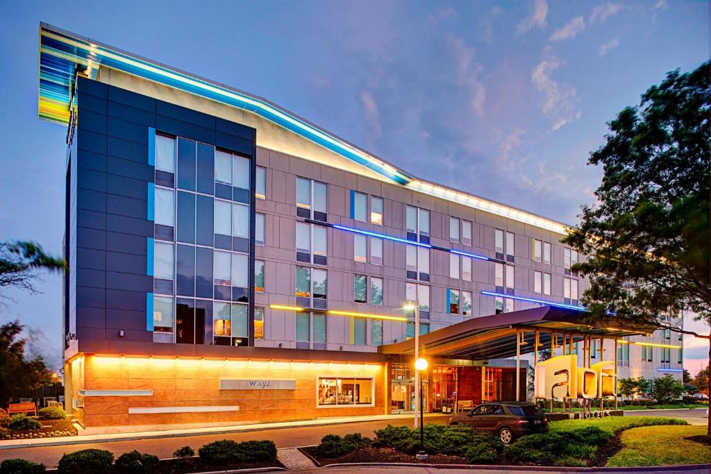 a building with a car parked in front of it at Aloft Philadelphia Airport in Philadelphia