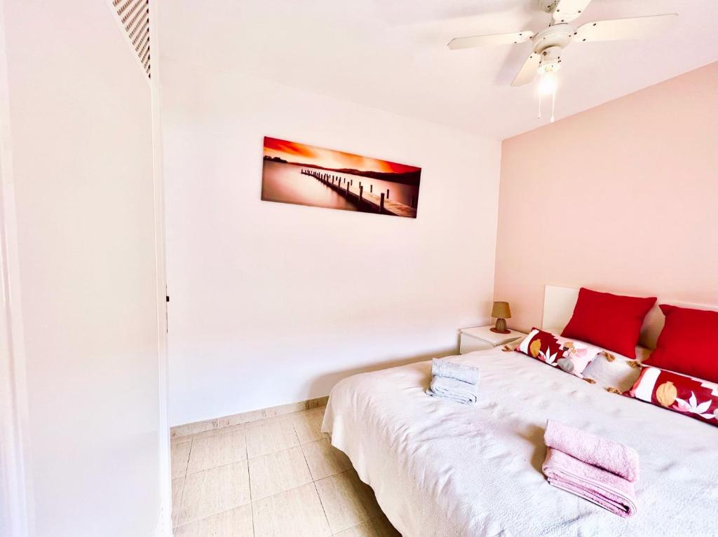 a bedroom with a bed and a painting on the wall at !!! Relaxing View, The Heights Apartment With Terrace and Heated Pools, Los Cristianos in Los Cristianos