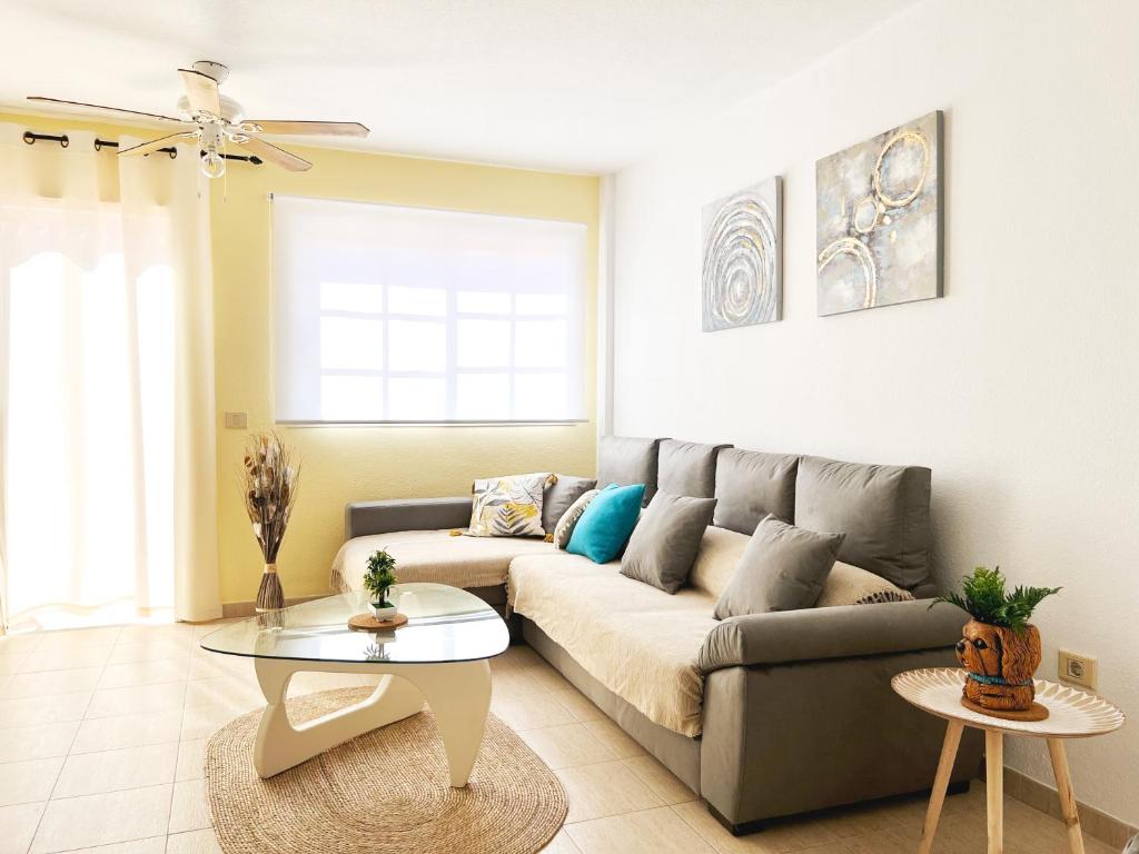 a living room with a couch and a table at !!! Relaxing View, The Heights Apartment With Terrace and Heated Pools, Los Cristianos in Los Cristianos