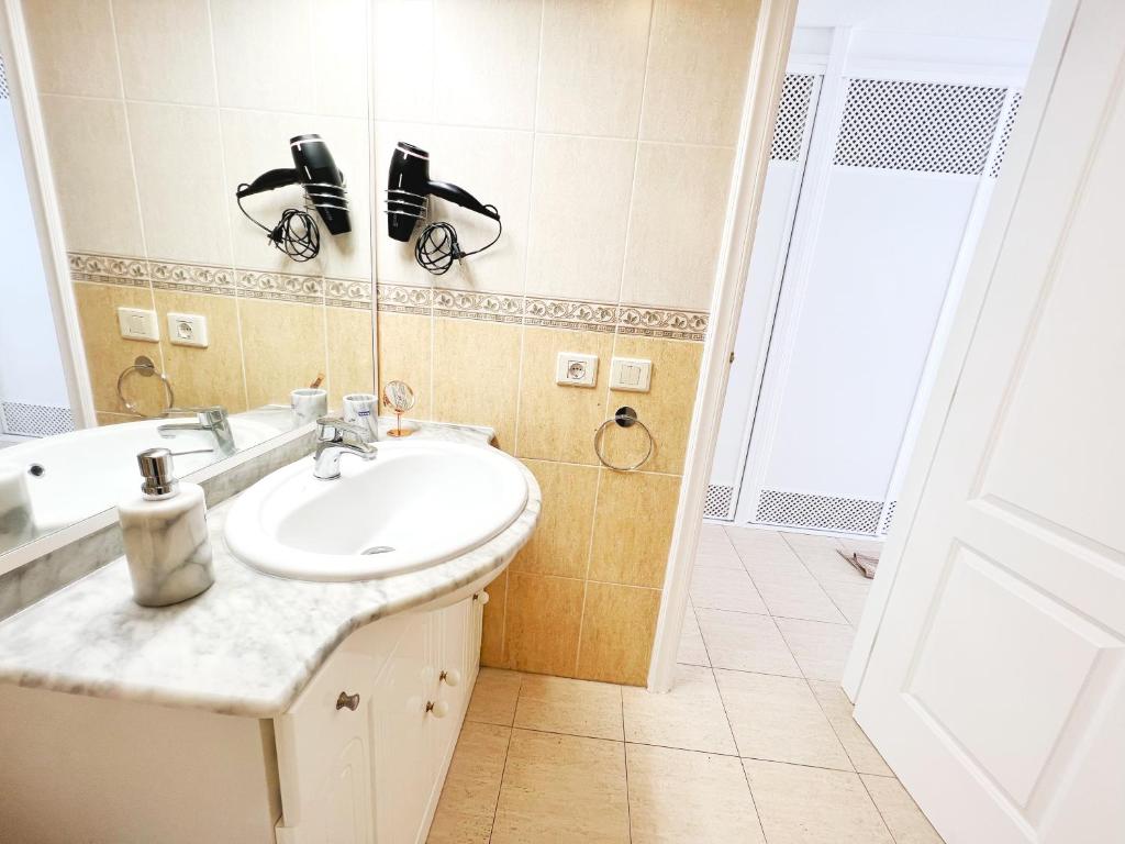 a bathroom with a sink and a mirror at !!! Relaxing View, The Heights Apartment With Terrace and Heated Pools, Los Cristianos in Los Cristianos