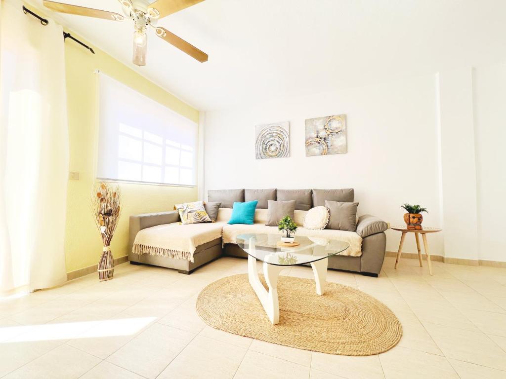 a living room with a couch and a table at !!! Relaxing View, The Heights Apartment With Terrace and Heated Pools, Los Cristianos in Los Cristianos