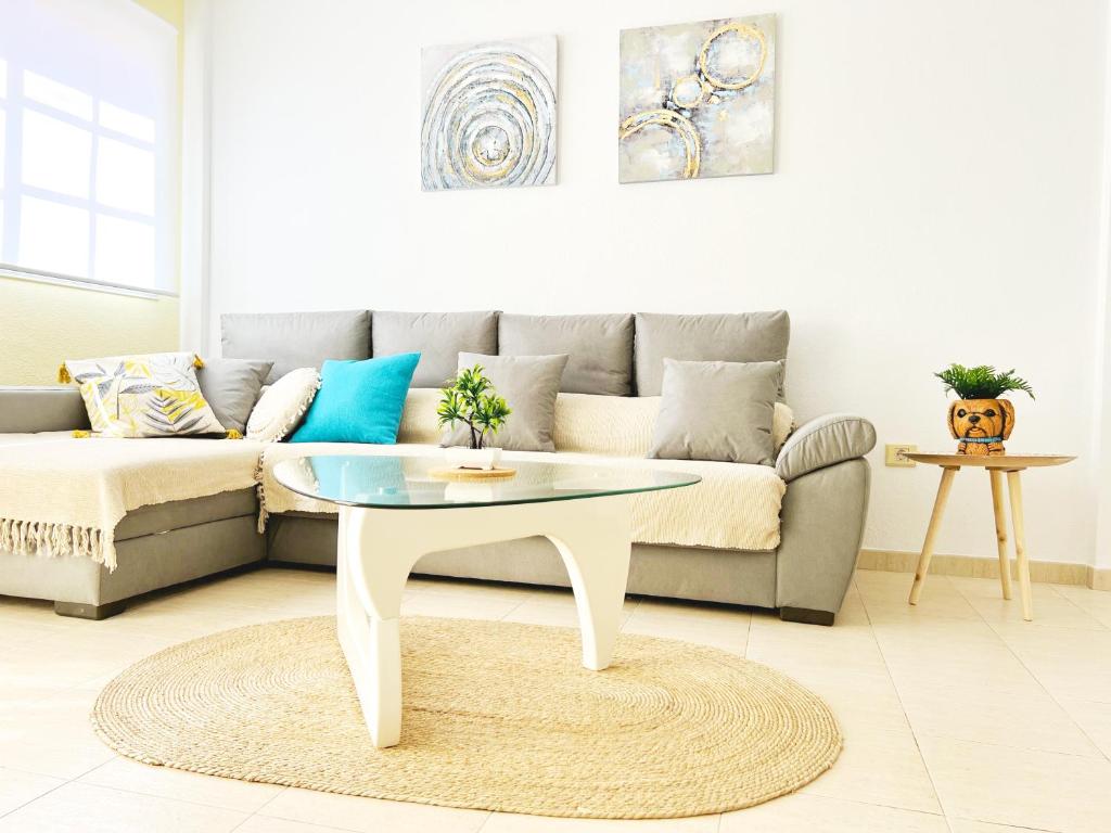 a living room with a couch and a table at !!! Relaxing View, The Heights Apartment With Terrace and Heated Pools, Los Cristianos in Los Cristianos