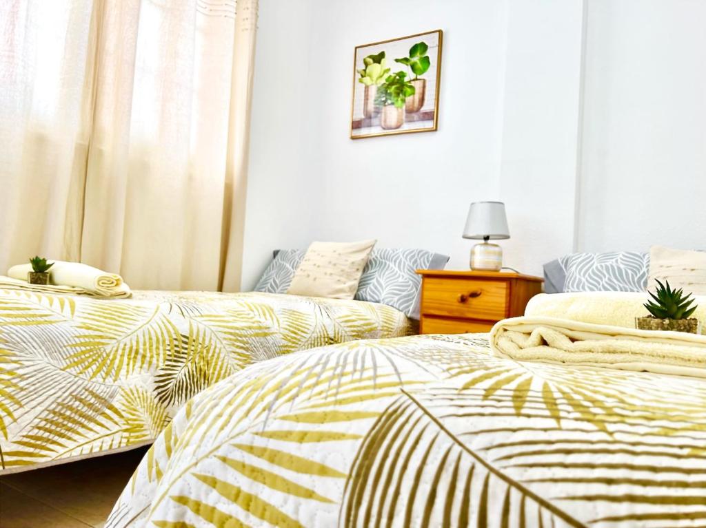 two beds sitting next to each other in a bedroom at !!! Relaxing View, The Heights Apartment With Terrace and Heated Pools, Los Cristianos in Los Cristianos
