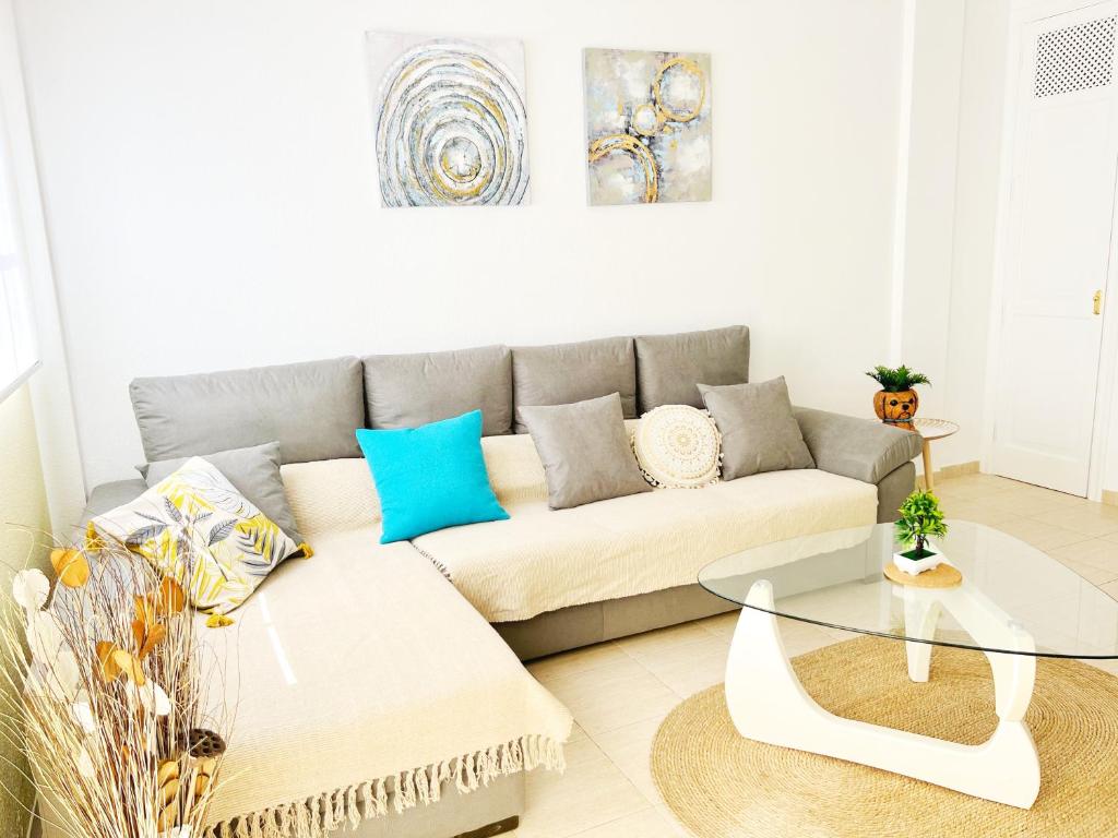 a living room with a couch and a glass table at !!! Relaxing View, The Heights Apartment With Terrace and Heated Pools, Los Cristianos in Los Cristianos