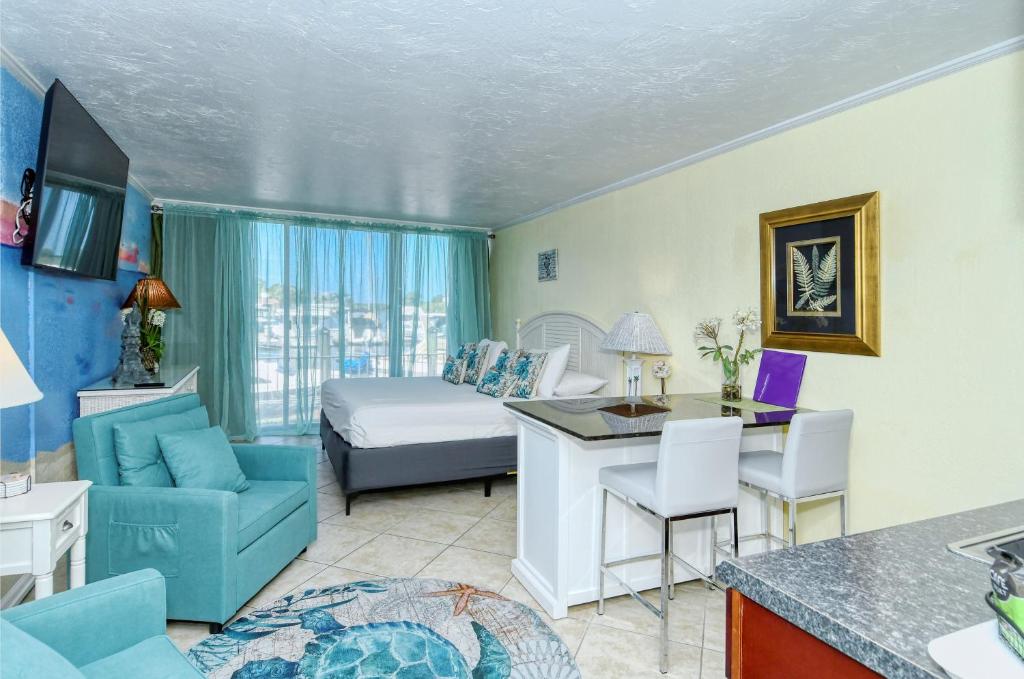 a living room with a room with a bed and a couch at Waterfront Room, Heated Pool, Tiki Bar & Grill in Sarasota