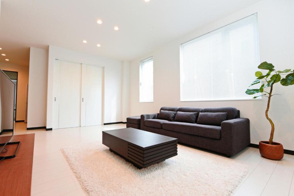 a living room with a couch and a coffee table at Sapporo - House - Vacation STAY 14578 in Sapporo