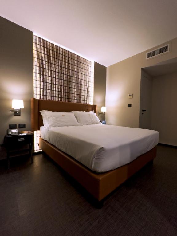 Postel nebo postele na pokoji v ubytování Hotel Orientale
