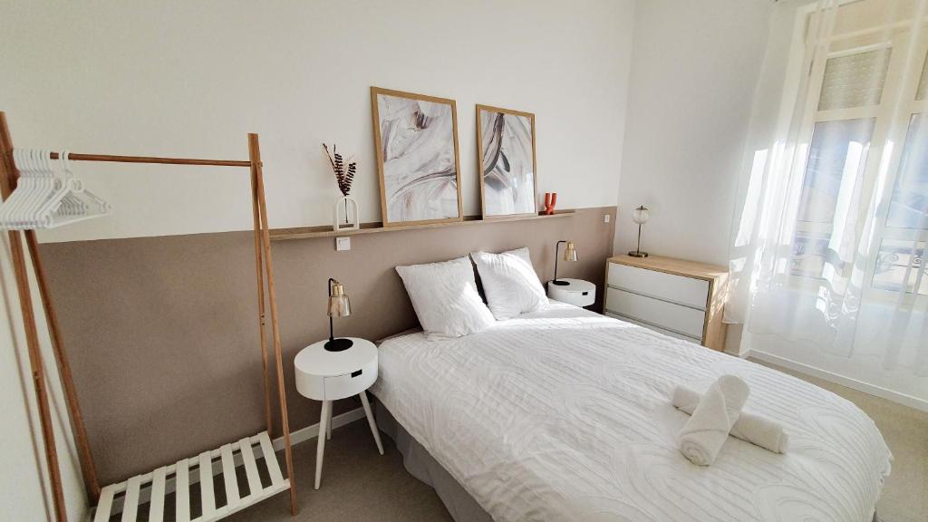 sypialnia z dużym łóżkiem i oknem w obiekcie Appartement T3 à deux pas du centre-ville w mieście Vichy