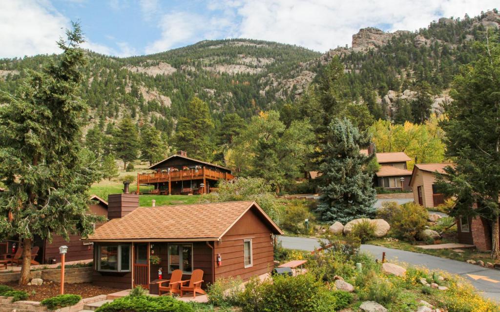 a house with a mountain in the background at McGregor Mountain Lodge in Estes Park