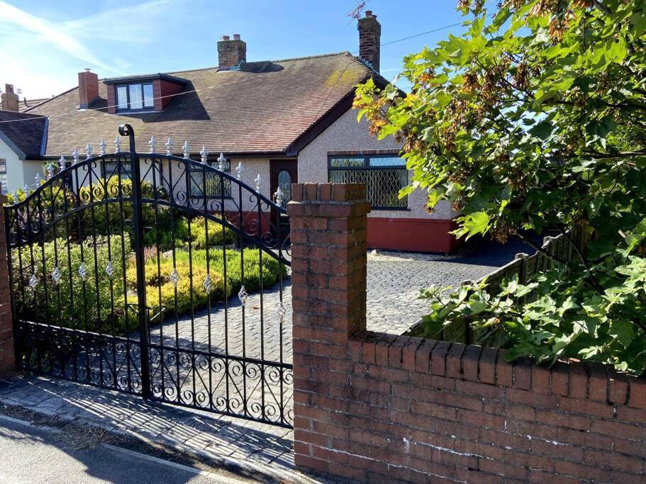 a wrought iron gate in front of a house at Quiet secluded two bedroom bungalow with parking in Cleveleys