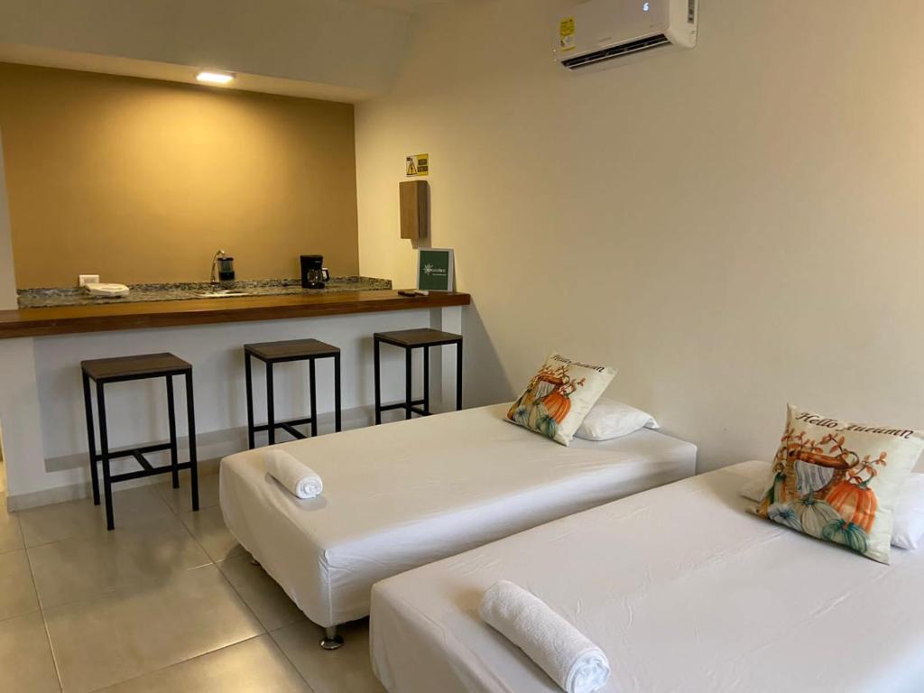 Postel nebo postele na pokoji v ubytování Hotel TACALOA INN EXPERIENCE