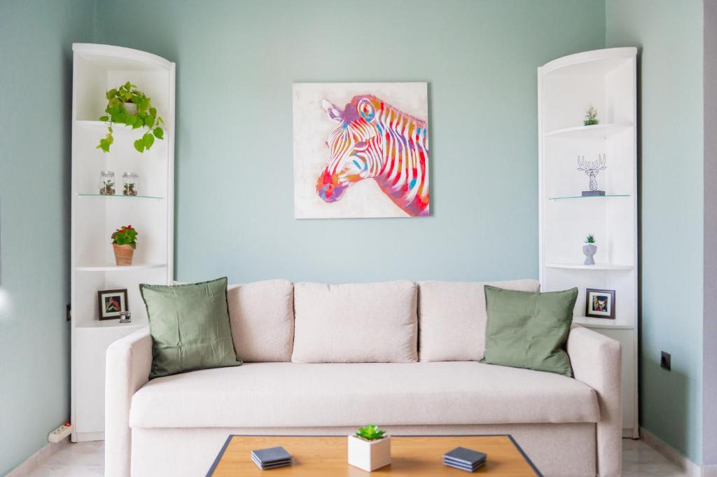 een woonkamer met een bank en een schilderij van een zebra bij The View in Alexandroupoli