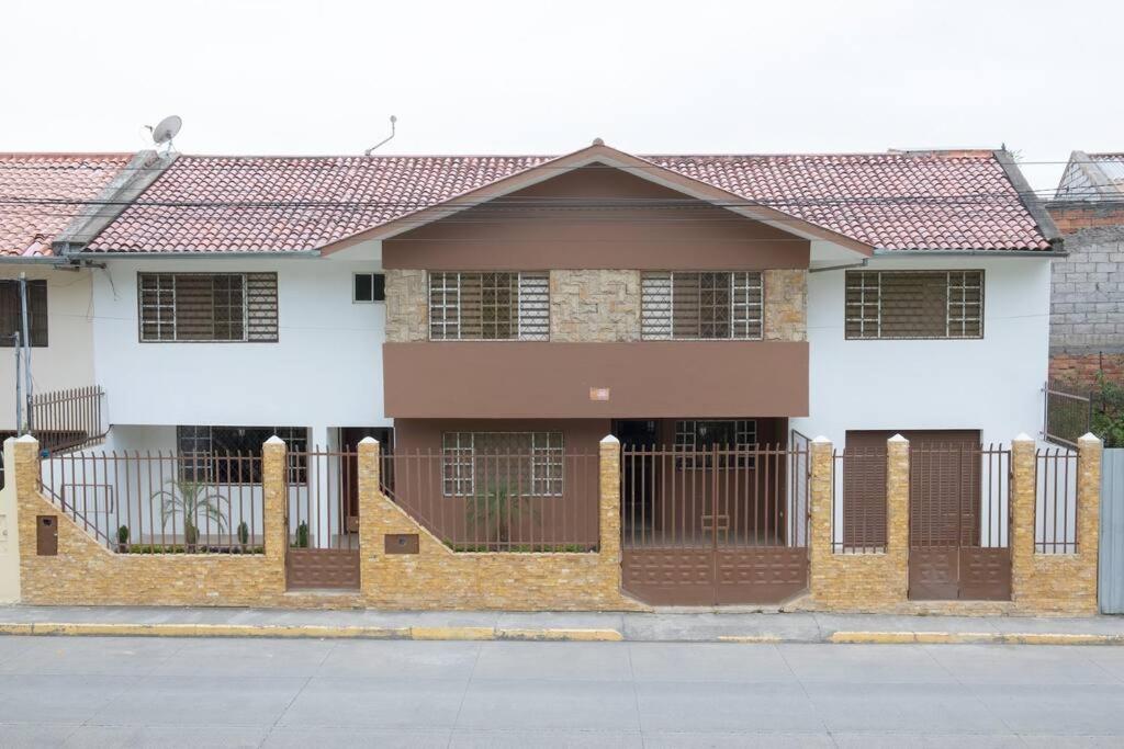 a house with a fence in front of it at Cozy & Spacious House-Near the Centro in Cuenca