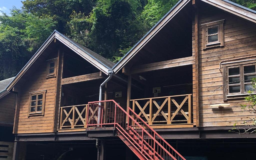 a log cabin with a deck and a balcony at village yumigahama - Vacation STAY 49340v in Minato
