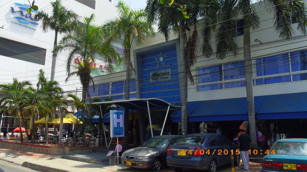 una calle con coches estacionados frente a un edificio en Mintaka Hotel + Lounge, en Cartagena de Indias
