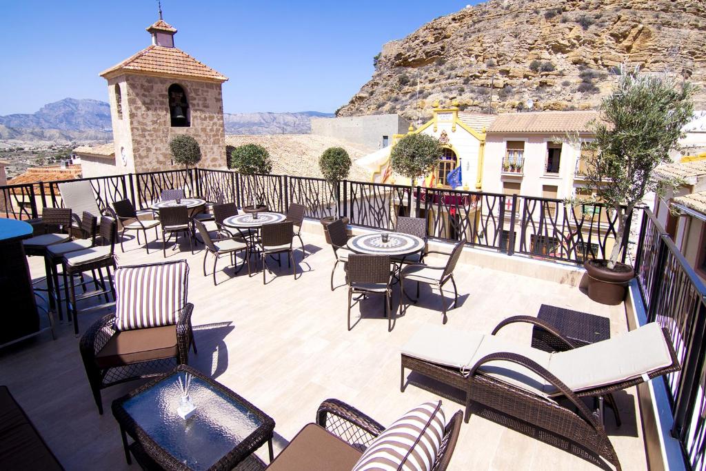 een patio met tafels en stoelen op een balkon bij Boutique Hotel Sierra de Alicante in Busot