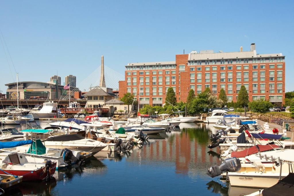 a bunch of boats docked in a harbor with a building at Residence Inn by Marriott Boston Harbor on Tudor Wharf in Boston