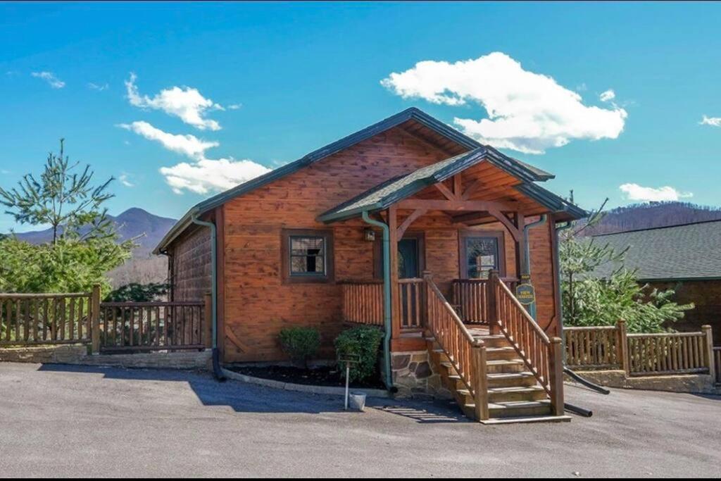 a log cabin with a porch and a deck at Cabin With Stunning Views, Hot Tub, Game Room in Gatlinburg