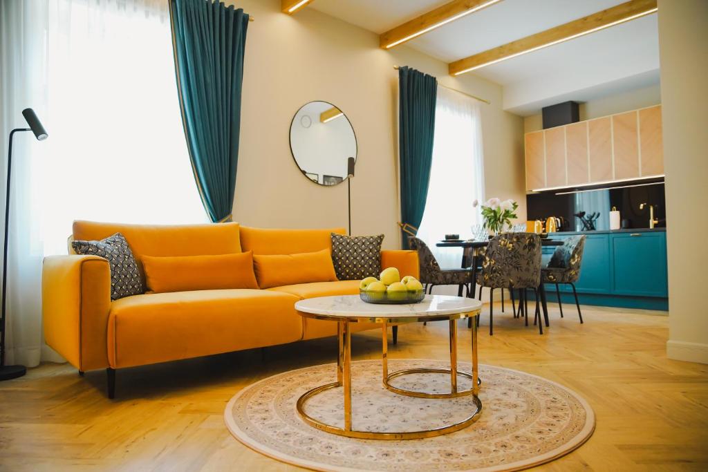 a living room with a yellow couch and a table at Meerbach Residents in Kuressaare