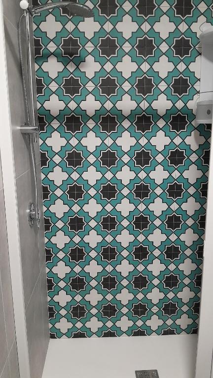 a bathroom with a tiled shower with a tile wall at Roslivia in Polignano a Mare
